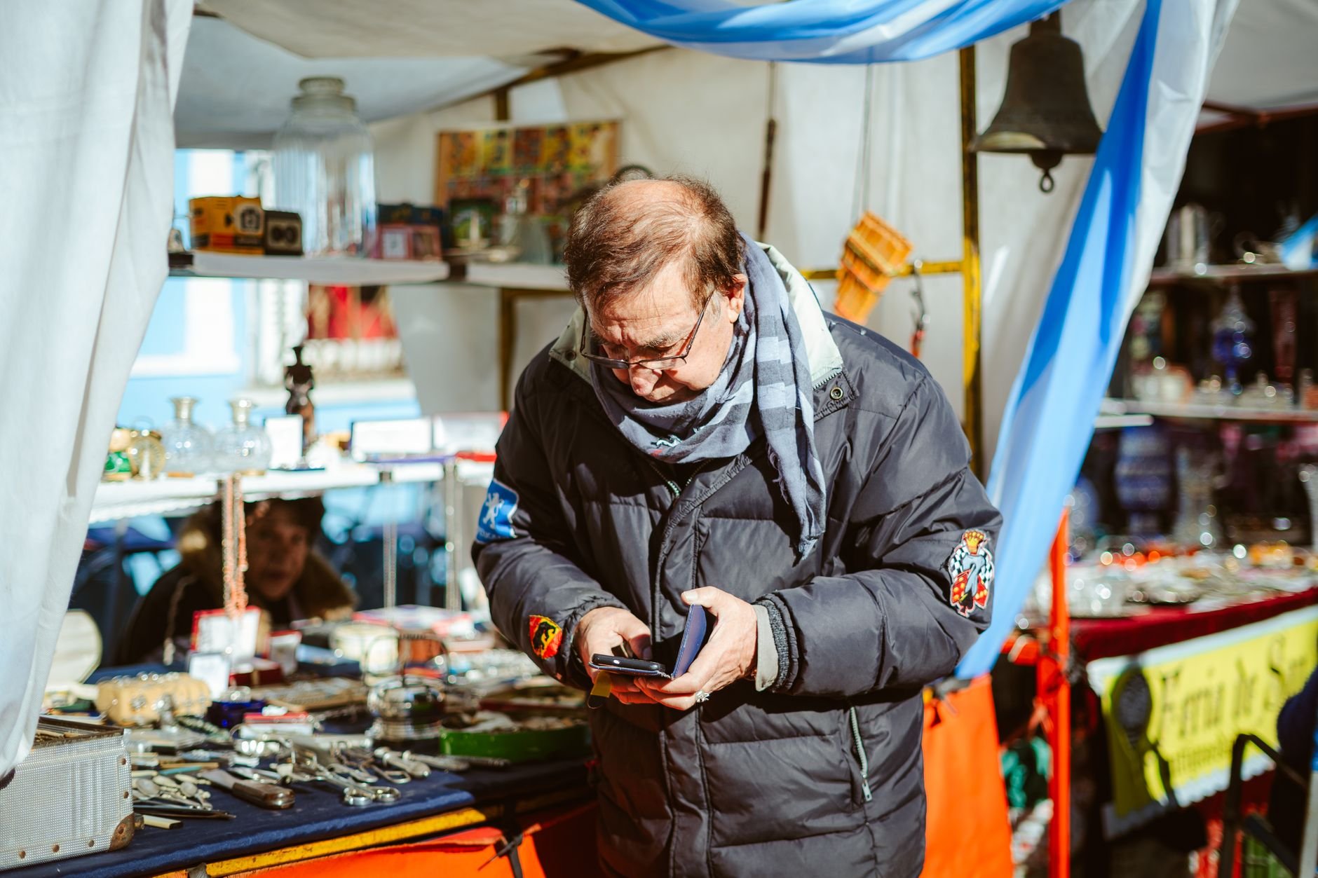 Man browsing items at a vibrant flea market.